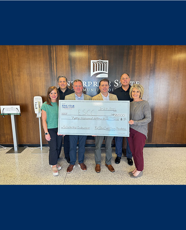 Enterprise State Community College scholarship check presentation.